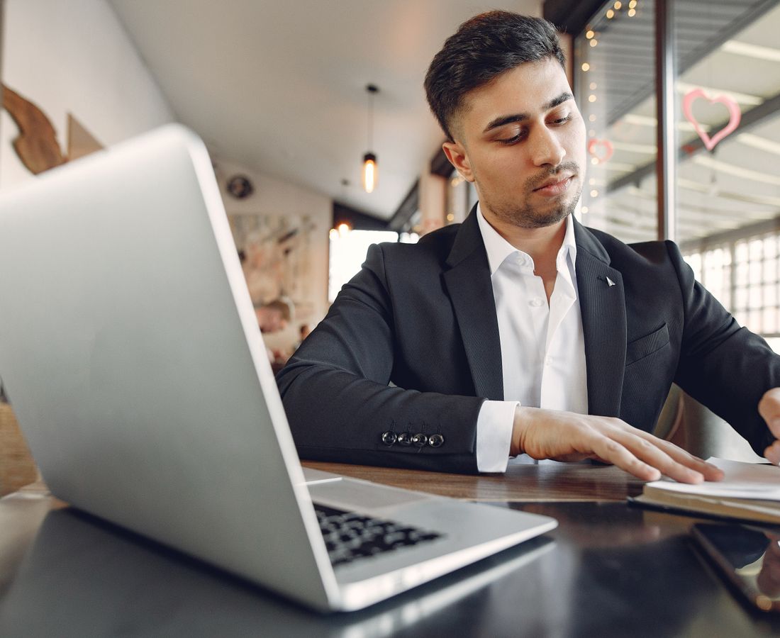 A professional working on a laptop in an office