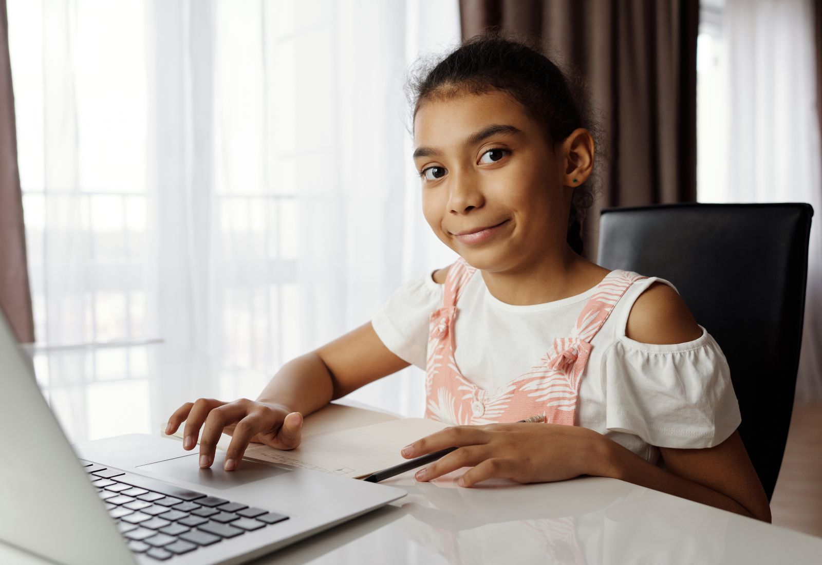 A girl smiling during an online English lesson